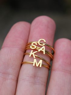 This elegant gold initial ring is perfect for stacking, making it a great gift for any occasion - whether a mother's day surprise or a best friend's birthday present. Crafted from quality stainless steel, this letter ring will look beautiful for years to come. Featuring a letter of your choosing, this ring can be worn alone or stacked making it perfect for gifting to friends or family. The subtle, yet sweet letter ring looks elegant alone or as part of a larger stack. This gold letter ring is th Adjustable Hypoallergenic Initial Ring For Anniversary, Adjustable Stackable Initial Ring As Gift, Minimalist Rings With Initials For Personalized Gift, Minimalist Jewelry With Letter Print For Gift, Gold Hypoallergenic Initial Ring For Anniversary, Mother's Day Anniversary Initial Ring, Hypoallergenic Initial Ring As Gift, Dainty Gold Stackable Rings With Initials, Personalized Initial Ring In Yellow Gold