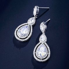 A delightfully unique pair of bridal earrings with an incredible sparkle! Adorned with flawlessly faceted cubic zirconia that capture the light in a dazzling array of sparkles, the earrings are rhodium plated for a bright finish which enhances the intricate detailing and conveys a modern take on old elegance. Overall length of the earring is 1.5" (approx. 4cm). Available in Silver, Rose Gold and Yellow Gold finishes. To make your choice select your preferred finish from the dropdown menu to add Dazzling Diamond White Crystal Bridal Earrings, Dazzling Diamond White Bridal Earrings With Crystal, Elegant White Gold Crystal Bridal Earrings, Diamond White Cubic Zirconia Chandelier Earrings With Sparkling Stones, Exquisite Diamond White Crystal Earrings, Dazzling Cubic Zirconia Chandelier Earrings For Anniversary, Dazzling Crystal Drop Bridal Earrings, Dazzling Crystal Bridal Earrings, Sparkling Cubic Zirconia Crystal Earrings