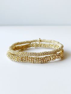 two gold bead bracelets Gold Wrap Bracelet With Tiny Beads As A Gift, Gold Hand-strung Wrap Bracelet Gift, Gold Stackable Wrap Bracelet, Gold Wrap Bracelet With Spacer Beads As Gift, Dainty Hand Wrapped Gold Beaded Bracelets, Dainty Hand-wrapped Gold Beaded Bracelets, Gold Spiritual Hand Wrapped Bracelets, Spiritual Hand Wrapped Gold Bracelets, Spiritual Hand-wrapped Gold Bracelets