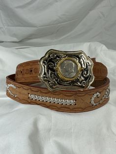 "You are looking at a vintage buckle with Kennedy Half Dollar buckle coin from 1974. The buckle measuring 3\"9 wide by 2\"7 high. Belt is made of tan leather with lovely white scorpions in good condition. Belt measures 50\" long, 1\"4 wide and is size 44. The buckle is adorned with silver and gold tone hardware and  Kennedy coin from 1974. Both the buckle and belt are in good condition and is a great vintage find.   I want to stress that item is vintage which means it's not new. All my customers Vintage Distressed Brown Belt Buckle With Antique Detail, Vintage Distressed Brown Belt Buckles With Antique Buckle, Vintage Handmade Brown Belt Buckles, Western Brown Antique Buckle Belt, Tan Leather Belt, Vintage Belts With Antique Buckle, Adjustable, Half Dollar, Scorpion, Post Office