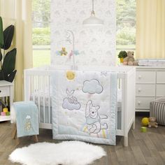 a baby crib with a teddy bear bedding set