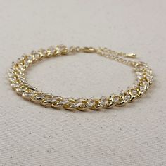 Indulge in luxury with our 18k Gold Filled Iced Chunky Cuban Bracelet. The sparkly, glamorous design will elevate any outfit, making you feel like a true fashion icon. Treat yourself or a loved one to the ultimate statement piece. Metal: 18k Gold Filled AAAAA Cubic Zirconia Stones Sizes : 7.25 inches +2 inches extender Hypoallergenic Water-resistant Handcrafted in Brazil Glamorous Sparkling Bracelets For Party, Glamorous Sparkling Bracelet For Party, Gold Bangle-style Chain Bracelet For Parties, Gold Bangle Chain Bracelet For Party, Elegant Gold Chain Bracelet With Sparkling Stones, Glamorous Sparkling Stones Bracelets For Party, Glamorous Sparkling Stones Bracelet For Party, Gold Plated Bangle Chain Bracelet For Parties, Modern Chunky Chain Bracelets For Party