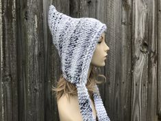 "Knit Hat Style: Pixie Hat - a chunky pointed bonnet with knitted ties, for women, men and teens. Color: This sample hat is shown in White Marble, a white base with grey streaks. Sizes: One size fits average teen or adult head size of 20\" to 23\" (50.5 cm to 58 cm). Fiber Content: 80% acrylic, 20% Wool Characteristics: Whimsical, chunky, very soft, warm and cozy. Care Instructions: Hand wash, dry flat. Every item from Pixiebell is handmade and knit or crocheted to order, unless otherwise stated Grey Streaks, Ties For Women, Gray Streaks, Chunky Hat, Chunky Knit Hat, Mens Hat, Pixie Hat, Handmade Knitwear, Womens Hat