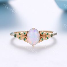 You are looking at a vintage Lab-created opal and round cut lab emerald engagement ring.A perfect anniversary gift, birthday gift,wedding engagement ring. Ring Information Main Stone *Lab-created white opal *6x8mm oval cut *Weight:it's approx 1.2 ct. *Setting:8-prong Side Stone *Lab created emerald Metal * Solid 10k 14k &18k. *Color:white gold,yellow gold,rose gold. Custom Order *The main stone can be other gemstones you can imagine,any birthstone can be made.Please contact me if you need this s Opal And Emerald Ring Set, Heirloom Green Opal Ring As Gift, Heirloom Style Green Opal Ring Gift, Heirloom Green Opal Ring Gift, Opal Anniversary Ring Fine Jewelry, Fine Jewelry Opal Ring For Anniversary, May Birthstone, Heirloom Style Emerald Ring As Gift, Round Cabochon Emerald Promise Ring, Elegant Opal Birthstone Ring With Accent Stones