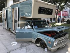 an old truck with a camper attached to it