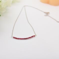 Garnet Properties: Protection ✨ Friendship ✨ Trust ✨  Sizes Available: 15" choker length. 18" standard necklace length. 20" length. 22" length. 24" length. Closure Metals Available: Stainless steel. 18K gold filled. Materials:  3 mm garnet beads 2.5 extender chain in stainless steel or 18k gold filled. Lobster clasp and chain in stainless steel or 18k gold filled. Tarnish-resistant beading wire. Shipping I ship each item individually within 1-3 days. Free Shipping on $35+ orders. Ground shipping Dainty Red Birthstone Necklace, Red Ruby Birthstone Necklaces, Dainty Red Necklace For Anniversary, Red Necklace With Adjustable Chain As Gift, Red Necklace With Adjustable Chain For Gift, Red Adjustable Chain Necklace As A Gift, Red Single Strand Necklace For Gift, Red Choker Necklace For Gift, Dainty Red Birthstone Necklace For Gift