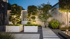 an outdoor patio area with plants and potted plants on the side of the building