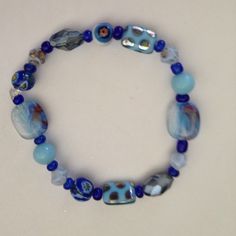 Glass beaded bracelet Very pretty glass bead bracelet in blues.  New, stretch Jewelry Bracelets Casual Glass Beaded Bracelets, Handmade Casual Glass Bracelets, Casual Handmade Glass Bracelets, Casual Handmade Glass Bracelet, Casual Glass Bracelets As Gift, Casual Blue Hand-strung Beaded Bracelets, Casual Blue Hand-strung Bracelets, Blue Glass Beaded Bracelets With Faceted Beads, Handmade Blue Beaded Bracelets With Czech Glass