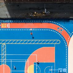 an overhead view of a basketball court with people playing