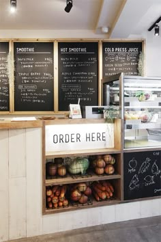 an outside view of a store with menus on the wall and food in baskets