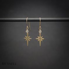 "You'll shine when you will wear this celestial dangle earrings. This dangle north stars with hanging zircon stone is perfect to wear at work, holidays, and even for a party. ★Comes in our signature gift box, ready for gift giving. ★ Available in Gold [ gold-filled ear wires & gold plated brass & zircon stone ] ★ Earring size (star+zircon) 1\"x0.50\". Thanks for shopping at ByYaeli♥ All images, texts & products are property of ByYaeli ©2020" 14k Gold Filled Earrings With Star Charm As Gift, Elegant Star-shaped 14k Gold Filled Jewelry, Elegant 14k Gold Filled Star Jewelry, Dainty Star Charm Drop Earrings, Celestial Style Earrings With Ear Wire For Everyday, Celestial Style Everyday Earrings With Ear Wire, Everyday Celestial Style Earrings With Ear Wire, Celestial Star-shaped Crystal Earrings For Gift, Celestial Star-shaped Crystal Earrings Gift