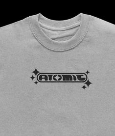 a grey t - shirt with the word atomic on it