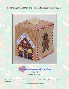 a small box with a gingerbread man and house on the front, it is made out of yarn