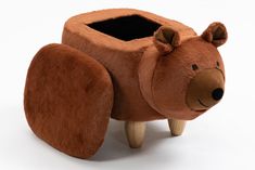 a brown bear shaped planter sitting on top of a wooden stand