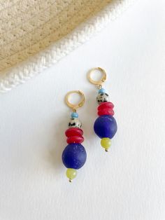 Add a burst of color to your collection with the Mecca Earrings. These vibrant earrings feature a delightful mix of various glass beads, lampwork beads, and brass accents, meticulously crafted to create a playful and unique accessory. Diverse Bead Composition: Each earring boasts a lively blend of various glass beads and lampwork beads, creating a colorful and dynamic design. Brass Accents: Delicate brass details add a touch of sophistication, enhancing the overall bohemian charm. Lever Back Earring Posts: Designed for comfort and security, ensuring a worry-free and enjoyable wear. Statement Length: These earrings measure 2 inches, making them a versatile and eye-catching addition to your jewelry collection. Materials: Various glass beads, lampwork beads, brass accents, lever back earring Fulani Earrings, Unique Composition, Beaded Bookmarks, Wine Glass Charms, Bone Beads, Stylish Earring, Creating Jewelry, Burst Of Color, Earring Posts