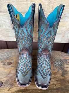 This Corral Women's Western Boot in rich Brown with its fancy turquoise leaves us speechless. Its stunning good looks include a trendy square toe. This boot is everything a cowgirl could want for that special boot in her collection. Turquoise and brown leather Brown overlay Embellished with brass studs Leather lining Leather outsole Double stitch welt Goodyear welt construction Walking heel Square toe 1.5" heel 12" Shaft 15.5" Calf Circumference ﻿Measurements for this boot were taken from a size Turquoise Western Boots With Patina, Western Turquoise Boots With Patina, Western Style Blue Boots For Ranch, Blue Western Style Boots For Ranch, Blue Western Boots For Ranch, Western Turquoise Boots For Fall, Western Turquoise Boots For Rodeo, Turquoise Western Boots For Ranch, Blue Western Boots For Western-themed Events