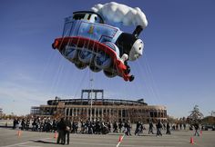 a large balloon shaped like thomas the train is being flown