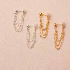 Our dangle chain earrings are a fun accessory that can be worn anywhere, from holiday parties to work. Pair them with any outfit for the perfect balance of fun and flirty. These minimalist earrings also make a very thoughtful birthday gift for the minimalist. …………………………………. Details: Chain is 14K Gold Filled or Sterling Silver Stud is 14k Gold Filled, measuring 4mm or Sterling Silver measuring 3mm Waterproof and can be worn all the time Perfect for Sensitive Ears About Your Jewelry If you are not Trendy Dangle Cartilage Earrings For Party, Trendy Cartilage Earrings With Adjustable Chain, Sterling Silver Drop Cartilage Earrings For Party, Dainty Single Cartilage Earring For Party, Elegant Dangle Chain Cartilage Earrings, Elegant Dangle Cartilage Earrings With Adjustable Chain, Sterling Silver Ear Wire Cartilage Earrings For Party, Sterling Silver Threader Dangle Earrings For Party, Elegant Dangle Cartilage Earrings For Parties