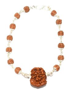 "Product Name : Ganesha Rudraksha Bracelet In silver Bead size : Ganesha Rudraksha (19 mm - 20 mm) , five face rudraksha (6 mm) Design : 1 bead of high quality Ganesha rudraksha of nepal in pure silver attached with small 5 mukhi rudraksha beads ,in silver caps and silver wire having traditional knots design . Origin : Nepal Description : Ganesh Rudraksha bears a Trunk like elevation as is seen on the face of Lord Ganesha, the son of Lord Shiva. Ganesha, the elephant-headed God of success and ov Spiritual Silver Bracelets For Diwali, Adjustable Sterling Silver Bracelets For Diwali, Adjustable Spiritual Jewelry For Diwali, Fusion Style Bracelets For Rituals And Festivals, Spiritual Bangle For Puja, Spiritual Silver Beads Bracelet As Gift, Adjustable Spiritual Jewelry For Puja, Spiritual Silver Bracelets For Navratri, Spiritual Silver Beads Mala Gift