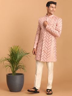 Pink Mirror Indo Western Sherwani Set Look your ethnic best in this stunning pink mirror work sherwani set. Crafted from a silk blend, this designer piece features a stylish fitted sherwani with a full-front button placket, long sleeves, and multiple slits. The cream-colored pants are designed for comfort with an elasticated waistband and button closure. Key Features Pink mirror work design Stylish fitted silhouette Full-front button placket Long sleeves with multiple slits Cream-colored solid p Mirror Work Design, Indo Western Sherwani, Pink Mirror, Mens Ethnic Wear, Colored Pants, Work Design, Ethnic Dress, Mirror Work, Indo Western