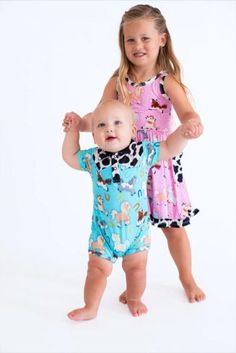 This shortie romper is an adorable one-piece outfit that's perfect for your favorite mini cowboy! The romper is crafted from bamboo viscose and spandex, making it gentle on sensitive skin, highly breathable, and durable. This outfit is an easy-wear choice that offers a comfortable fit and soft feel for your little one. The perfect outfit of the day in one adorable piece! Playful Fitted Onesie For Loungewear, Cute Short Sleeve Jumpsuits And Rompers For Playtime, Playful Fitted Jumpsuits And Rompers For Loungewear, Spring Fitted Bubble Romper For Playdate, Fitted Bubble Romper For Spring Playdate, Fitted Bubble Romper For Playdate In Spring, Summer Cotton Stretch Onesie, Cute Short Sleeve Onesie For Summer, Fun Short Sleeve Onesie For Summer