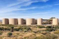 several large round concrete structures in the desert