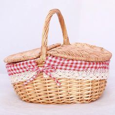 a wicker basket with a red and white checkered ribbon