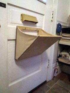 a paper boat hanging on the side of a door