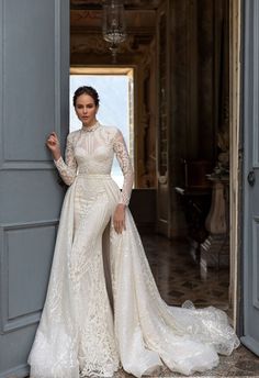 a woman in a wedding dress leaning against an open door with her hand on her hip