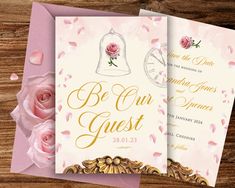 two wedding cards with pink roses and bells on them, sitting next to each other