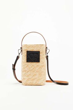 Beige straw mini bucket bag with silver-tone hardware a single leather top handle adjustable detachable leather shoulder strap and a pili and bianca patch on the front. includes a removable pouch with a drawstring fastening.    - outer: straw 90% leather 9% metal 1%  - made in italy  - height: 20cm width: 10cm depth: 10cm; handle: 11cm strap: 117cm Chic Natural Straw Bag With Mobile Phone Pocket, Luxury Crossbody Straw Bag For Summer, Modern Straw Bag With Removable Pouch For Summer, Straw Bucket Bag With Adjustable Strap, Modern Summer Straw Bag With Detachable Strap, Natural Straw Bucket Bag With Adjustable Strap, Summer Crossbody Bucket Bag For On-the-go, Natural Straw Bag For Summer On-the-go, Summer Top Handle Straw Bag For On-the-go