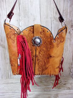 Bucket Bag Cowboy Boot Fringe PurseHand-cut FringeHand-Crafted from a Pair of BootsNo Two AlikeLeather Body/Leather strapWestern conchoSolid BaseMagnetic ClosureMeasures approx. 10”x13”FAQ'sReviews Western Leather Bags With Concho Details, Bohemian Leather Bag With Concho, Western Style Brown Bag With Concho, Bohemian Brown Bags With Concho, Western Bags With Concho Detail, Western Style Bags With Concho, Hand Tooled Western Bags, Western Brown Bag With Fringe, Brown Western Bag With Fringe