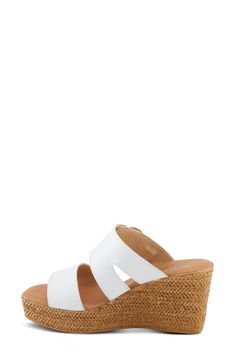 A gleaming instep buckle and wide vamp straps lend visual intrigue to a weekend-ready slide sandal lifted by a raffia-wrapped platform and wedge heel. 3" heel; 1" platform Adjustable strap with buckle closure Cushioned footbed Leather upper/synthetic lining and sole Made in Italy Modern Wedge Sandals With Buckle For The Beach, Modern Beach Wedge Sandals With Buckle, Modern Beach Wedge Sandals With Buckle Closure, Synthetic Slides With Heel Loop For Beach, Modern Wedge Heel Mules For Beach, Beach Slides With Heel Loop In Synthetic Material, Modern Slide Wedge Sandals For Beach, Synthetic Slide Wedge Sandals With Buckle Closure, Modern Beach Mules With Heel Loop