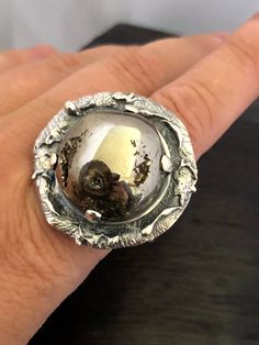 ARTISAN AMMONITE FOSSIL RING Hand-made Sterling Silver. Size 10 Stones used: Ammonite-Fossil Face of the ring: Height - 35mm, Width-35mm Height - 1 3/8', Width - 1 3/8' Band height - 12-9mm Please note: Colors may vary slightly due to monitor display settings. Items in the photograph are not actual size. Closeup photos are taken. Please read the measurements. Thank you for visiting! PLEASE VISIT MY OTHER SHOP FOR UNIQUE HANDCRAFTED ARTISAN JEWELRY https://www.etsy.com/shop/AlenaZenaJewelry or ju Unique Hand Cast Engraved Promise Ring, Artisan Hand Cast Round Rings, Handmade Open Ring For Collectors, Gift Dome Ring With Polished Finish, Handmade Collectible Open Ring, Sterling Silver Concave Dome Ring As Gift, Artisan Hand Cast Silver Rings, Unique Dome Ring With Polished Finish For Promise, Hand Cast Engraved Ring For Anniversary