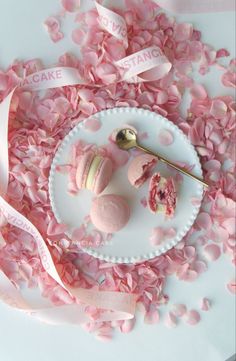 a plate topped with macaroni and cheese covered in pink confetti next to a spoon