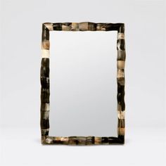 a square mirror sitting on top of a table