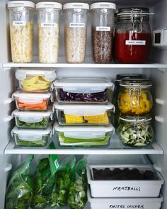 an open refrigerator filled with lots of food and containers full of different types of vegetables