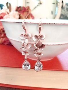 #dropearrings #dangleearrings #weddingearrings #bridalearrings #bridesmaidjewelry #bridesmaidgift #christmasearrings #lalacrystal #rosegoldjewelry #rosegoldearrings #orchidearrings #rosegoldorchid #holidaygift #gift for her Rose Gold Flower-shaped Earrings For Anniversary, Elegant Rose Gold Bridal Earrings For Party, Rose Gold Bridal Earrings With Elegant Design For Party, Feminine Rose Gold Flower Earrings For Gift, Feminine Rose Gold Flower Earrings As Gift, Wedding Rose Design Flower Earrings, Rose Gold Earrings With Elegant Design For Party, Elegant Rose Gold Teardrop Earrings For Anniversary, Rose Gold Flower Earrings For Party