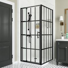 a black and white tiled bathroom with a walk in shower