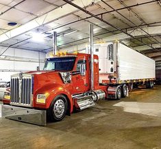 a large semi truck parked in a garage