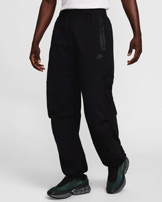 Crafted with stretchy woven material, these Nike Tech pants offer you ease of movement and adjustability. The wide-leg cut is paired with bungee locks at the ankles that let you switch up the fit. Shown: Black/Black/Black Style: HM7158-010 Nike Tech Pants, Tech Pants, Oversized Pants, Man Weave, Nike Joggers, Nike Tech, Mens Joggers, Black Style, Black Pants