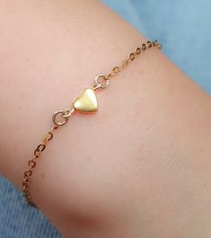 Tiny gold heart Bracelet. A beautiful bracelet with a tiny gold heart charm. ►Material: 14k Gold Filled ►Charm size: 6 mm ►Length: 6" - 8" This bracelet is: ► Nickel Free ✔ ► Tarnish Resistant ✔ ► No Allergic reaction ✔ ► 30 days return policy ✔  ► Accept replacements and custom orders ✔ ► I ship all items in a jewelry gift box ✔ ► Greeting card - upon request ✔  Shipping information : ► Tracking number ✔ ► Expedited / Express shipping - additional payment ooooooooooo ► My Shop: https://www.etsy Simple Gold Bracelets For Friendship, Delicate Gold Heart Bracelet For Gift, Dainty Adjustable Charm Bracelet With Heart Charm, Dainty Heart Charm Bracelet As Gift, Dainty Heart Bracelet For Gift, Dainty Heart Shaped Bracelet For Gift, Dainty Gold Chain Bracelet For Friendship, Gold Heart Bracelet With Delicate Chain As Gift, Dainty Heart Beads Bracelet For Gift