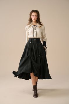 Favored for its versatility, this charming wool skirt is a perfect addition to your Victorian wardrobe!  This skirt combines elegance and whimsical charm with its silver-tone hardware detail and a Victorian-inspired design. With the clever design of the clips, you can easily change up your look. Clip the hem to create a stunning bustle effect, making you feel like a princess and adding a romantic touch to your overall look. Loosen the clips to let the skirt flow freely for a relaxed, casual vibe. Made from premium wool. The flattering silhouette and elegant design make it a versatile piece that can be dressed up or down, while the high-quality construction ensures comfort and durability. 【Fabric】 -Wool 87%, Elastane 13%. Fully lined. The softness and texture of high-quality wool add a touc Asymmetrical Skirt With Pockets In Relaxed Fit, Relaxed Skirt With Pockets For Fall, Asymmetrical Skirt With Pockets For Fall, Long Skirt With Pockets For Fall, Fitted Tiered Maxi Skirt With Pockets, Long Fall Skirt With Pockets, Vintage Tiered Skirt For Fall, Fall Asymmetrical Voluminous Skirt, Fitted Cargo Skirt With Lining For Fall