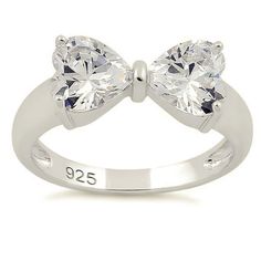 Top of ring height: 7.2mm Top of ring width: 14.8mm Band width: 4mm Shank width: 2.6mm Stone material: clear cubic zirconia Stone shape: heart cut Total number of CZ stones: 2 Stone setting: prong setting Metal: 925 sterling silver Plating: rhodium plated Finish: high polish Tanzanite Jewelry, Bow Ring, Stone Material, Silver Bow, Stone Setting, Lovely Ring, Cz Ring, Sterling Silver Heart, Cz Stone