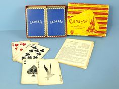 an old playing card set with four cards and two sets of instruction booklets in it