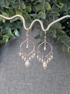 "20% OFF STOREWIDE!! MOTHER'S DAY is Sunday, MAY 14th!! Order now!  STUNNING Iridescent Freshwater Pearls and Sterling Silver Chandelier Earrings with Silver Sterling Teardrops and Sterling Silver Arabesque Ear Wires.  June birthstone: pearl Freshwater pearls are strong symbols of feminine energy. They are known to enhance personal integrity and support a sense of centeredness and calm.  DIMENSIONS: 2\" from the top of the ear wire 1 1/2\" from the bottom loop of the ear wire  ABOUT MY JEWELRY: Bohemian Silver Pearl Drop Jewelry, Bohemian Sterling Silver Pearl Drop Jewelry, Bohemian Sterling Silver Jewelry With Pearl Drop, Silver Drop Jewelry With Dangling Beads, Artisan Teardrop Jewelry For Anniversary, Artisan Ear Wire Wedding Jewelry, Artisan Jewelry With Ear Wire For Wedding, Artisan Wedding Jewelry With Ear Wire, Artisan Dangle Pearl Drop Earrings