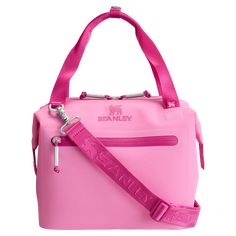 a pink handbag is shown with a strap around the bottom and side pockets on it