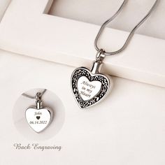 two heart shaped pendants are on display in a box with the message happy birthday mary