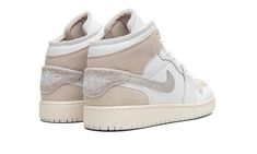 The Air Jordan 1 Mid SE Craft GS “White/Sail” is the youth sizing of the lifestyle sneaker with a deconstructed design.  The “White/Sail” features an “inside-out” look that gives the Jordan 1 Mid SE Craft a contemporary vibe.  The perforated leather toe panel sits on top of the toe cap—on a standard Air Jordan 1, this is reversed.  The suede overlays are designed in an undyed, natural hue that would typically appear on the inside of the shoe.  A tan suede Swoosh with orange reinforced bartacking Air Jordan 1 Mid Se, Nike Dunk High, Adidas Campus, Air Jordan 3, Stadium Goods, Jordan 13, Kids Jordans, Jordan 5, Jordan 3