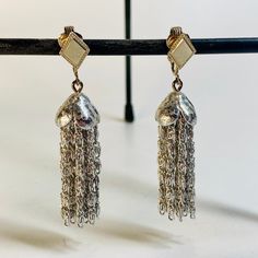 "Add a touch of vintage charm to your outfit with these stunning Sarah Coventry clip-on earrings. The silver tone dangle chain and tassel design is perfect for any occasion, from weddings to birthdays and everything in between. The rectangle shape and clip-on closure make them easy to wear. Approximately 2\" long and 1/2\" wide. These earrings are a wonderful addition to any jewelry collection. The signed Sarah Coventry brand ensures their originality and adds a touch of authenticity to your accessories. Don't miss out on these one-of-a-kind earrings that are sure to turn heads wherever you go." Sarah Coventry, Coventry, Rectangle Shape, Vintage Charms, Clip On, Clip On Earrings, Etsy Earrings, Jewelry Collection, Silver Tone